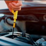 Checking engine oil level using dipstick for car maintenance in Kenya