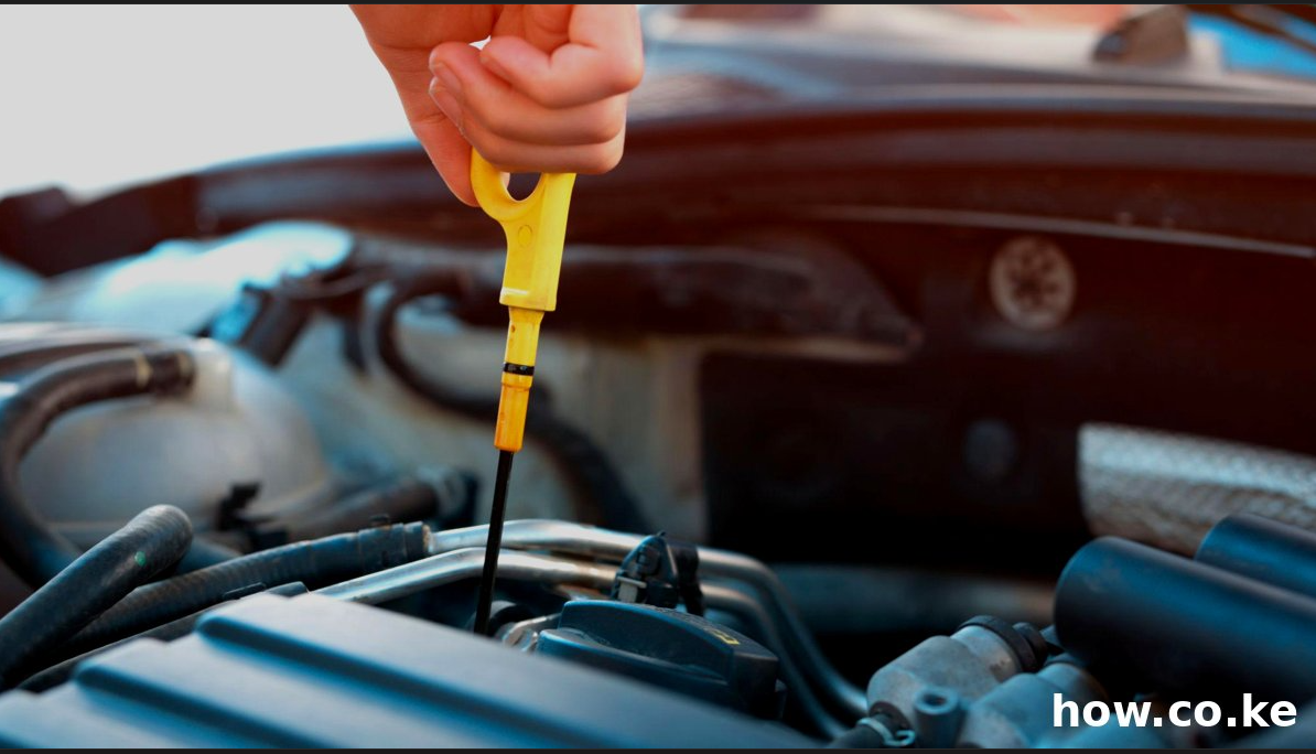 Checking engine oil level using dipstick for car maintenance in Kenya